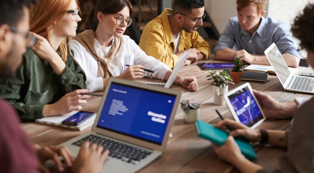 Photo Of Online Reputation Management Professionals Leaning On Wooden Table