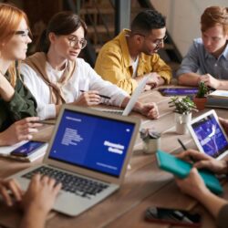 Photo Of Online Reputation Management Professionals Leaning On Wooden Table