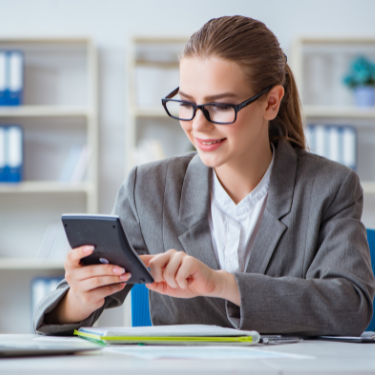 financial professional sitting at a desk using a calculator - reputation management for financial services