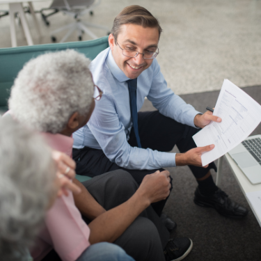 insurance representative sitting with an older man and landy giving information about insurance - reputation management for insurance services